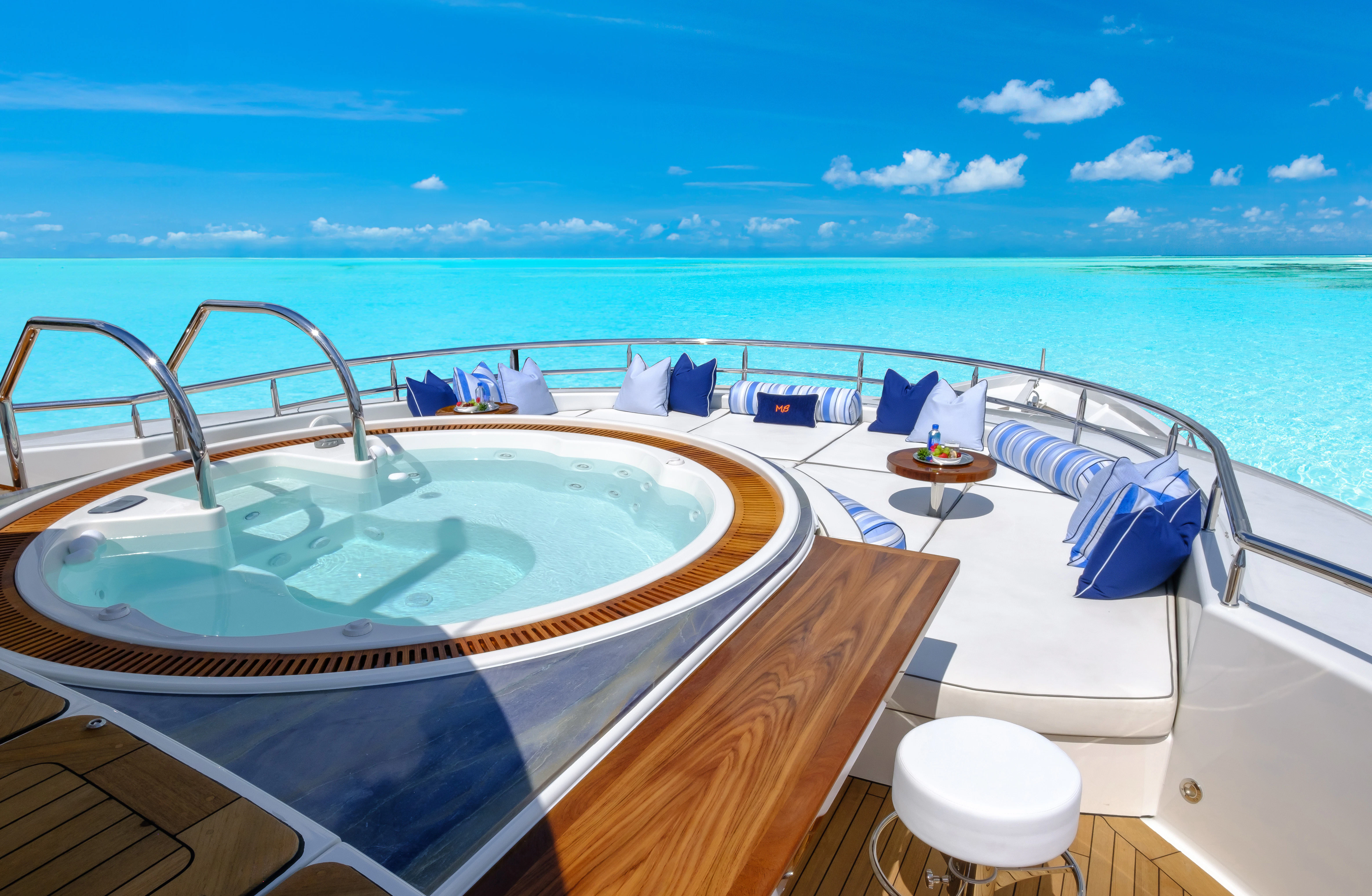 a large pool on a balcony overlooking the ocean aboard MAISON BLANCHE Yacht for Charter