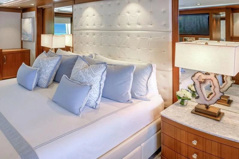 a bed with a white bed spread aboard MAISON BLANCHE Yacht for Charter