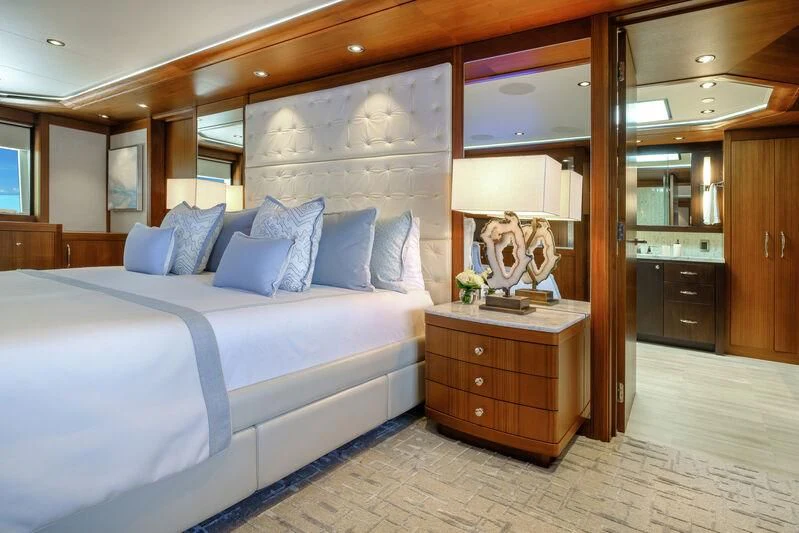a bedroom with a bed and a dresser aboard MAISON BLANCHE Yacht for Charter