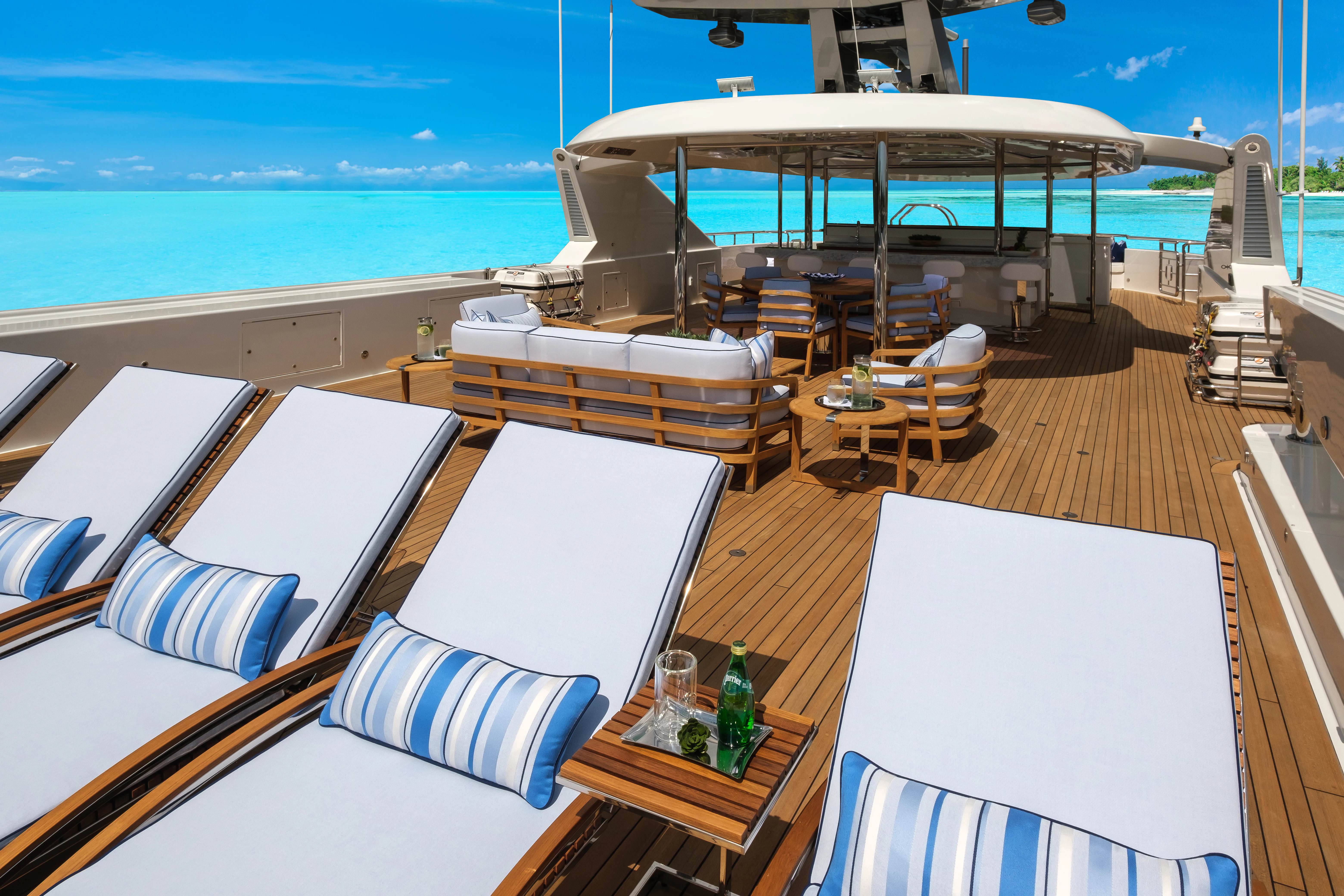 a room with a table chairs and a large body of water aboard MAISON BLANCHE Yacht for Charter