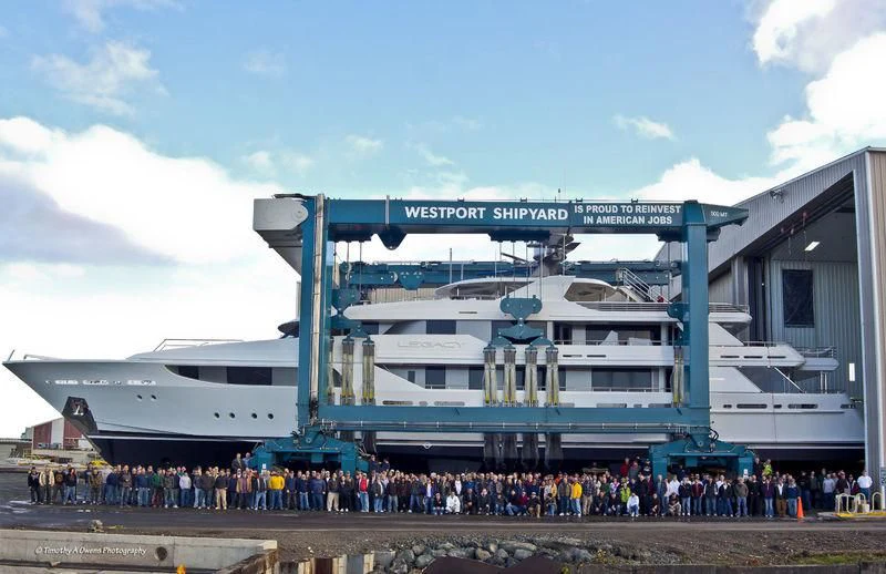 a group of people standing outside a building aboard MAISON BLANCHE Yacht for Charter