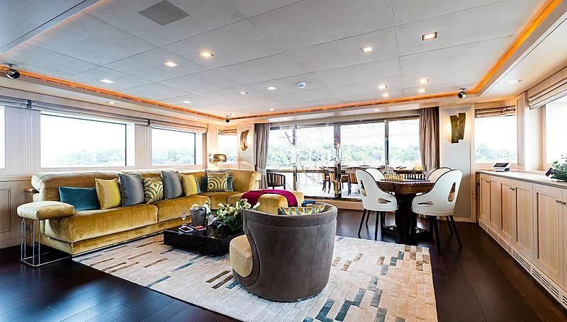 a living room with a couch and a table aboard PHOTON Yacht for Sale