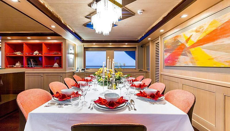 a dining room with a table and chairs aboard PHOTON Yacht for Sale
