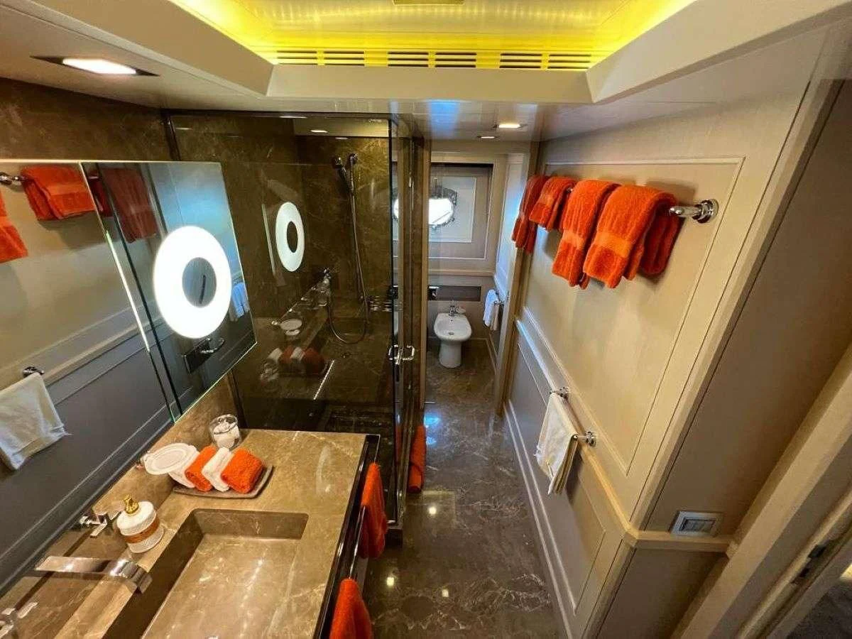 a bathroom with a countertop sink and mirror aboard PHOTON Yacht for Sale
