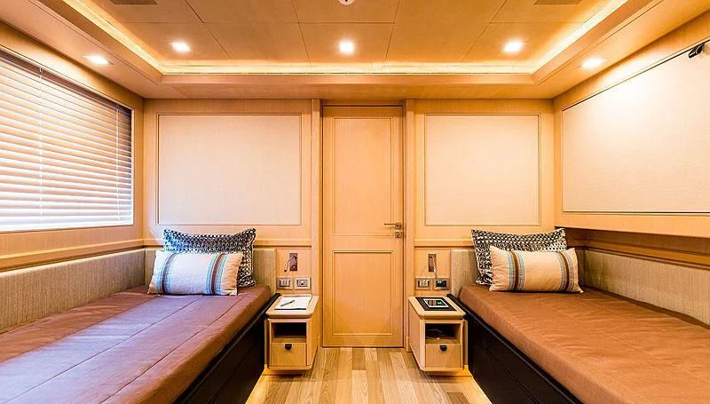 a room with two beds aboard PHOTON Yacht for Sale