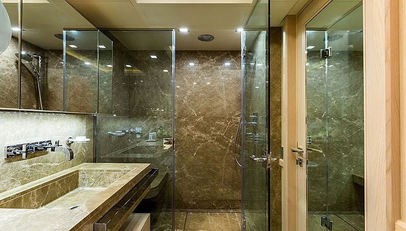 a bathroom with a large glass shower aboard PHOTON Yacht for Sale