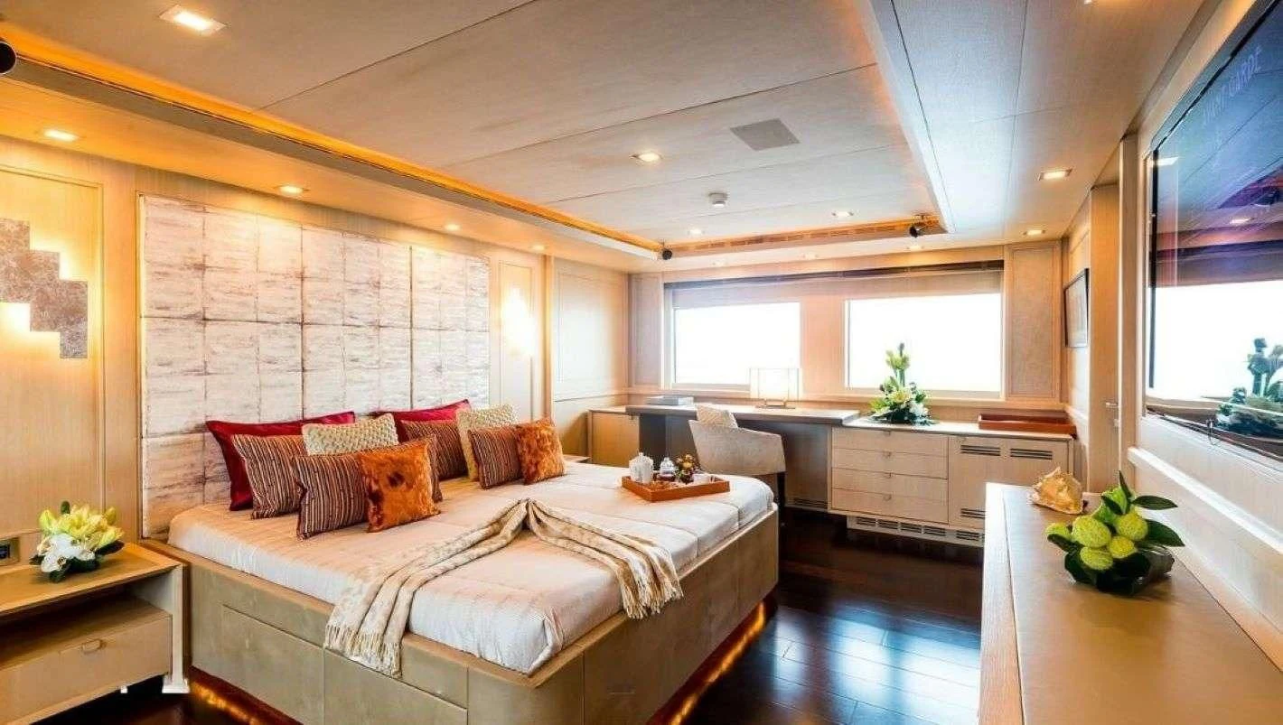 a large bedroom with a large bed aboard PHOTON Yacht for Sale