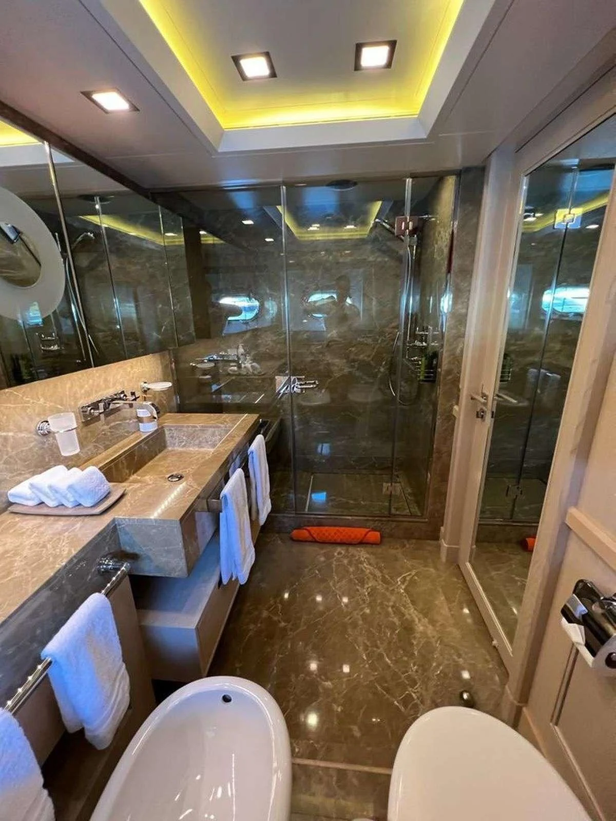 a bathroom with a countertop sink and a shower aboard PHOTON Yacht for Sale