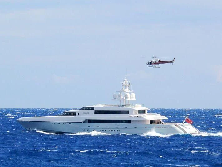 a helicopter flying over a boat aboard RABDAN Yacht for Sale