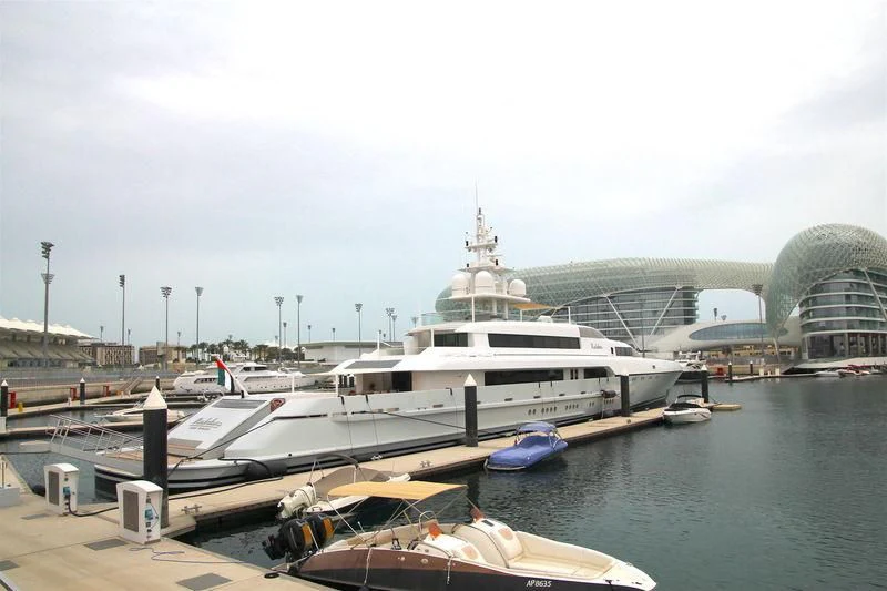 a large white boat sits at a dock aboard RABDAN Yacht for Sale