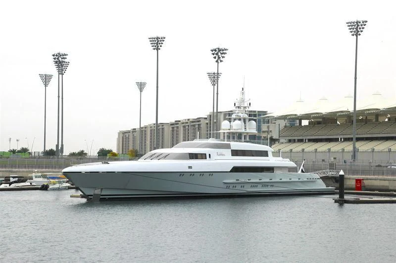a white yacht in a harbor aboard RABDAN Yacht for Sale