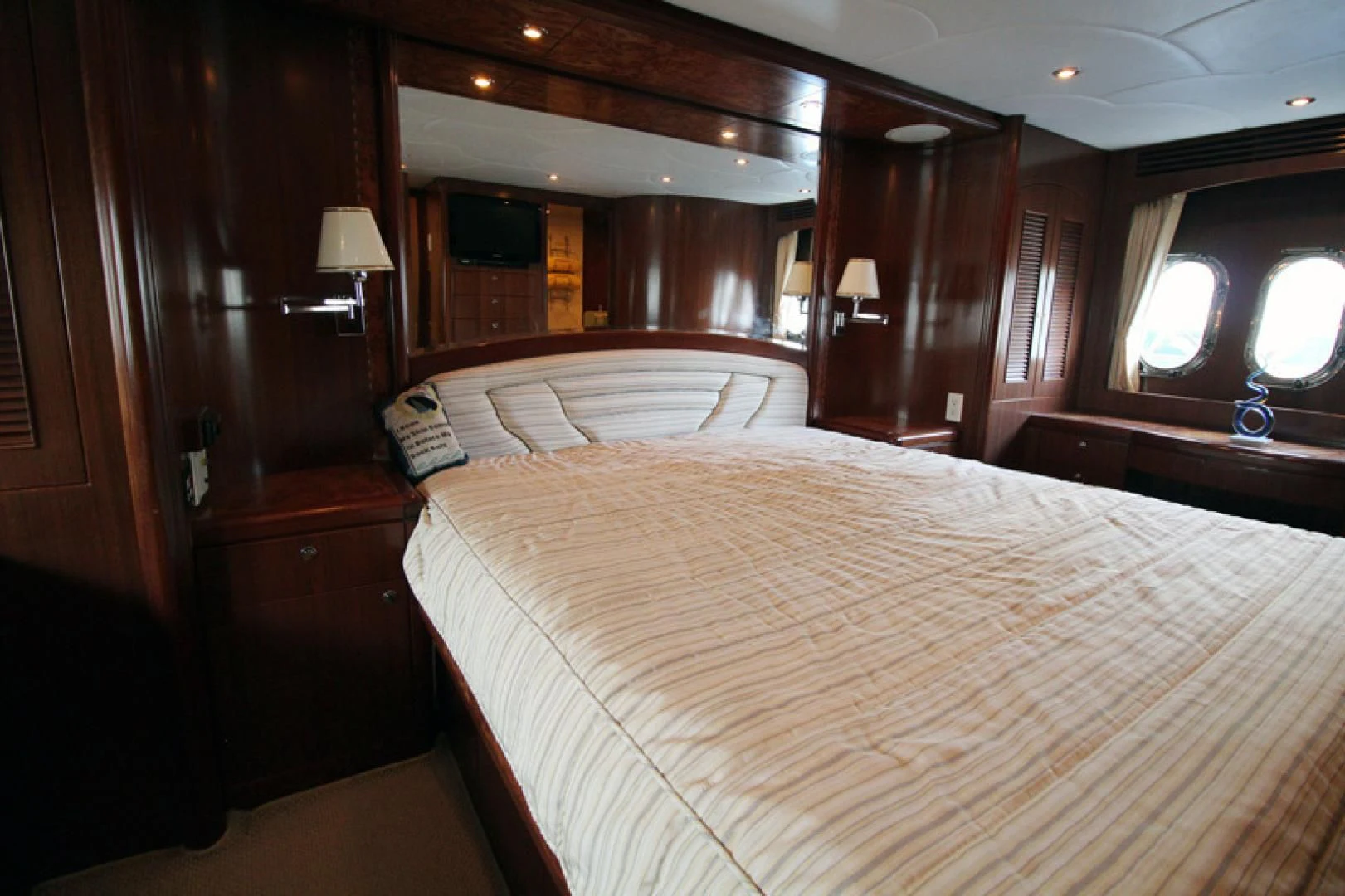 a room with a bed and a lamp aboard ALWAYS SOMETHING Yacht for Sale