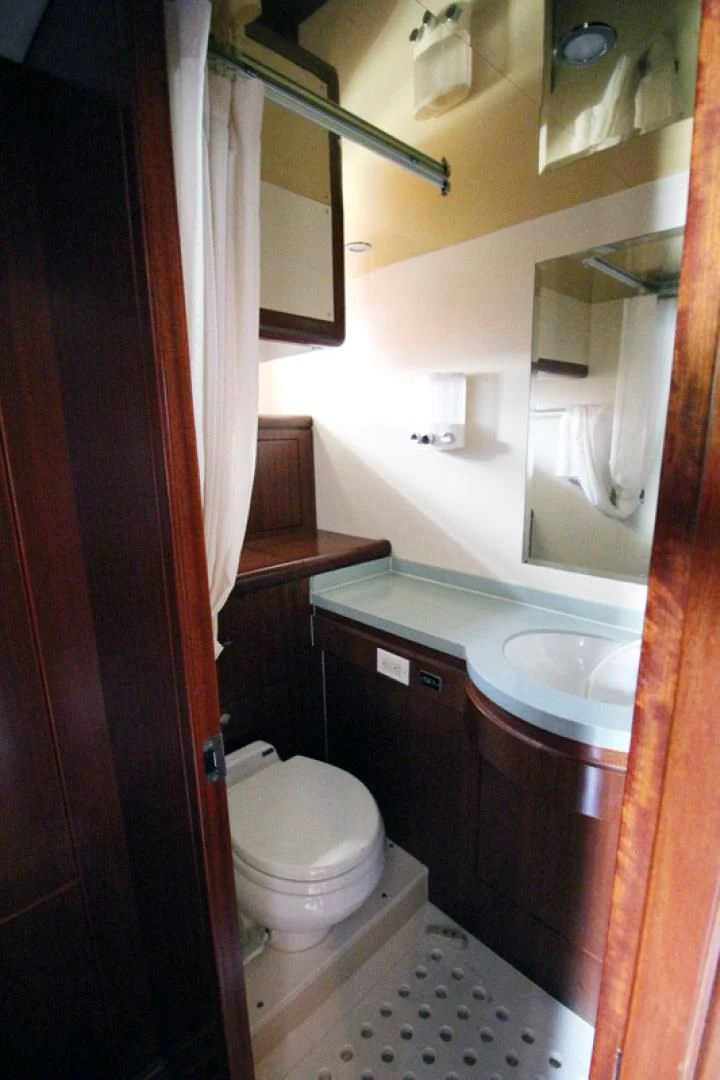 a bathroom with a toilet sink and a mirror aboard ALWAYS SOMETHING Yacht for Sale
