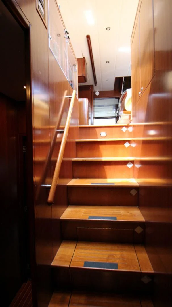 a wooden staircase with wooden railings aboard ALWAYS SOMETHING Yacht for Sale