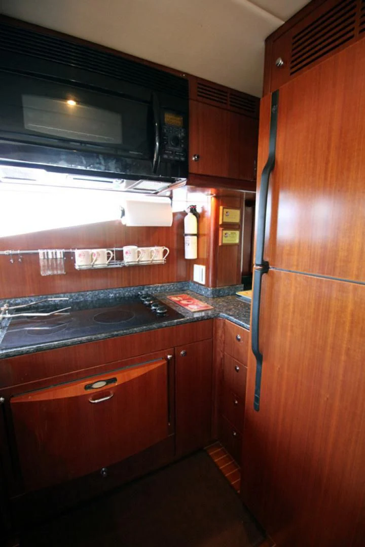 a kitchen with wooden cabinets aboard ALWAYS SOMETHING Yacht for Sale