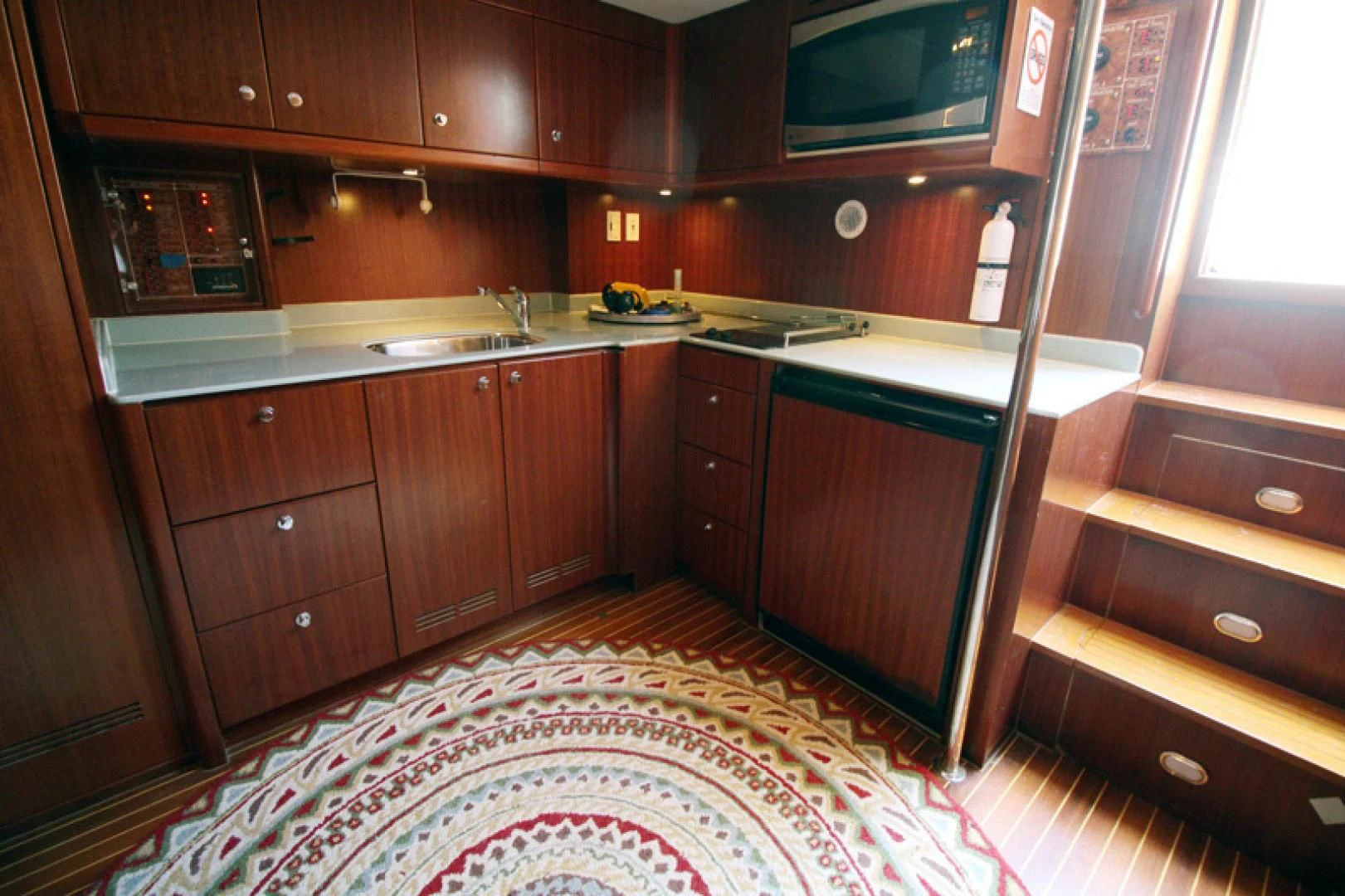 a kitchen with wooden cabinets aboard ALWAYS SOMETHING Yacht for Sale