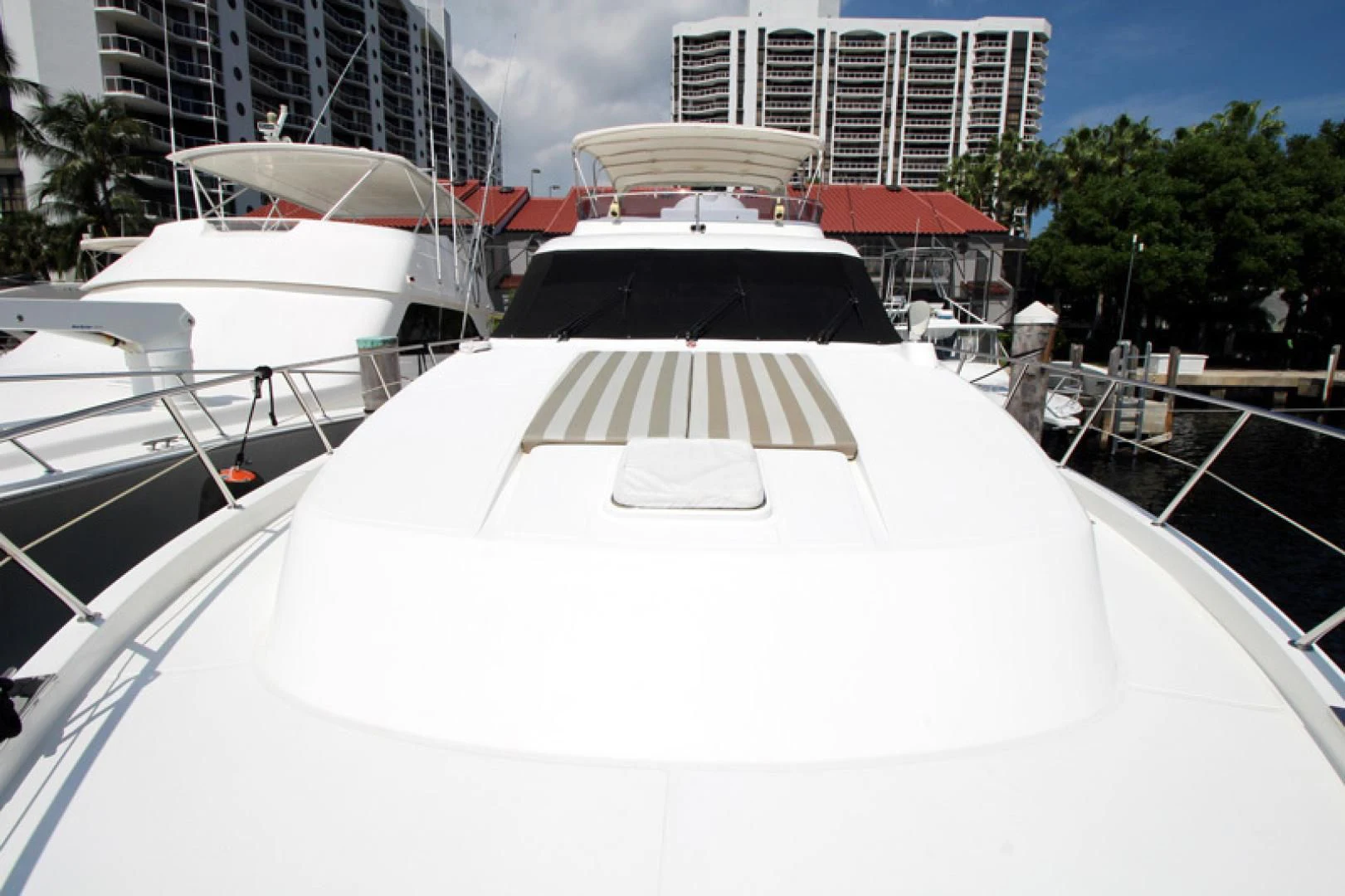 a white boat with a black and white striped roof aboard ALWAYS SOMETHING Yacht for Sale