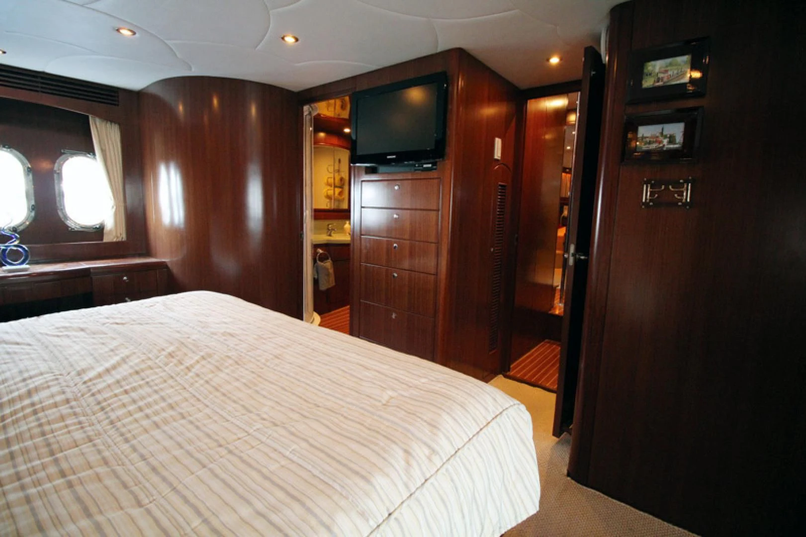 a bedroom with a bed and a tv aboard ALWAYS SOMETHING Yacht for Sale