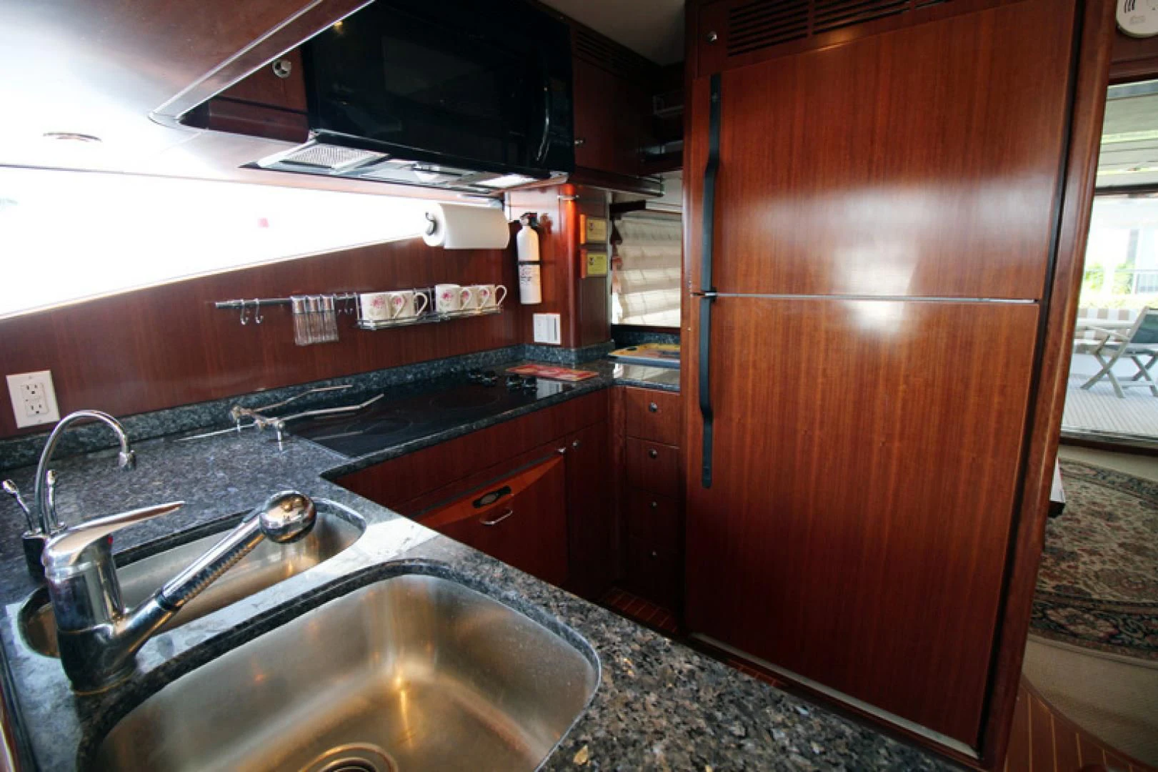 a kitchen with wooden cabinets aboard ALWAYS SOMETHING Yacht for Sale