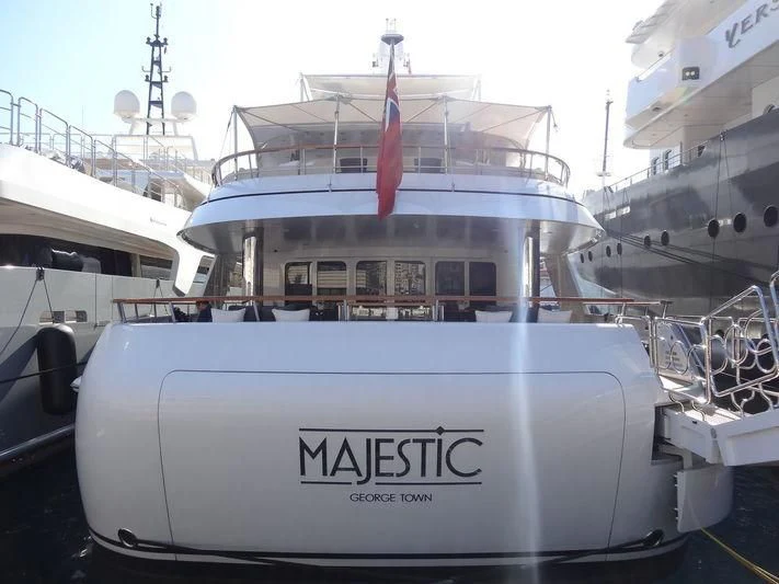 a large white boat in a harbor aboard MAJESTIC Yacht for Sale