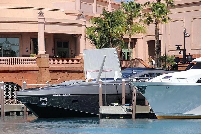a couple of boats sit in a harbor aboard PURE INSANITY Yacht for Sale