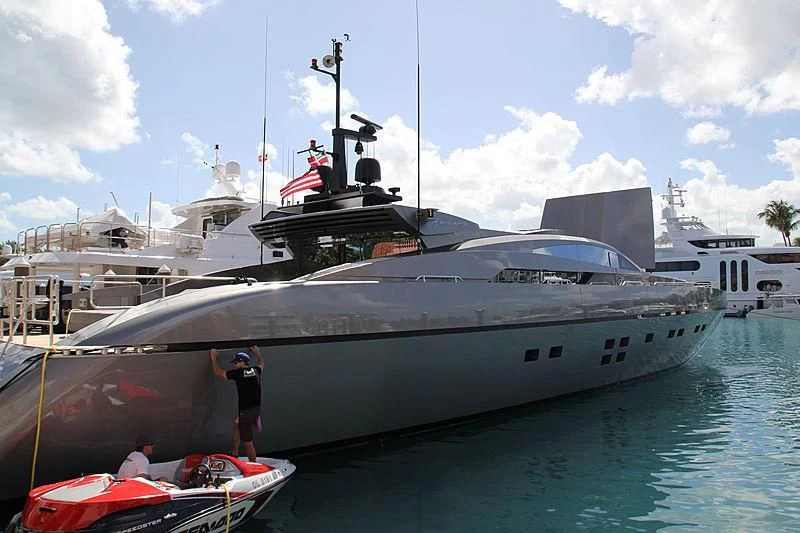 a large white boat with a flag on it aboard PURE INSANITY Yacht for Sale