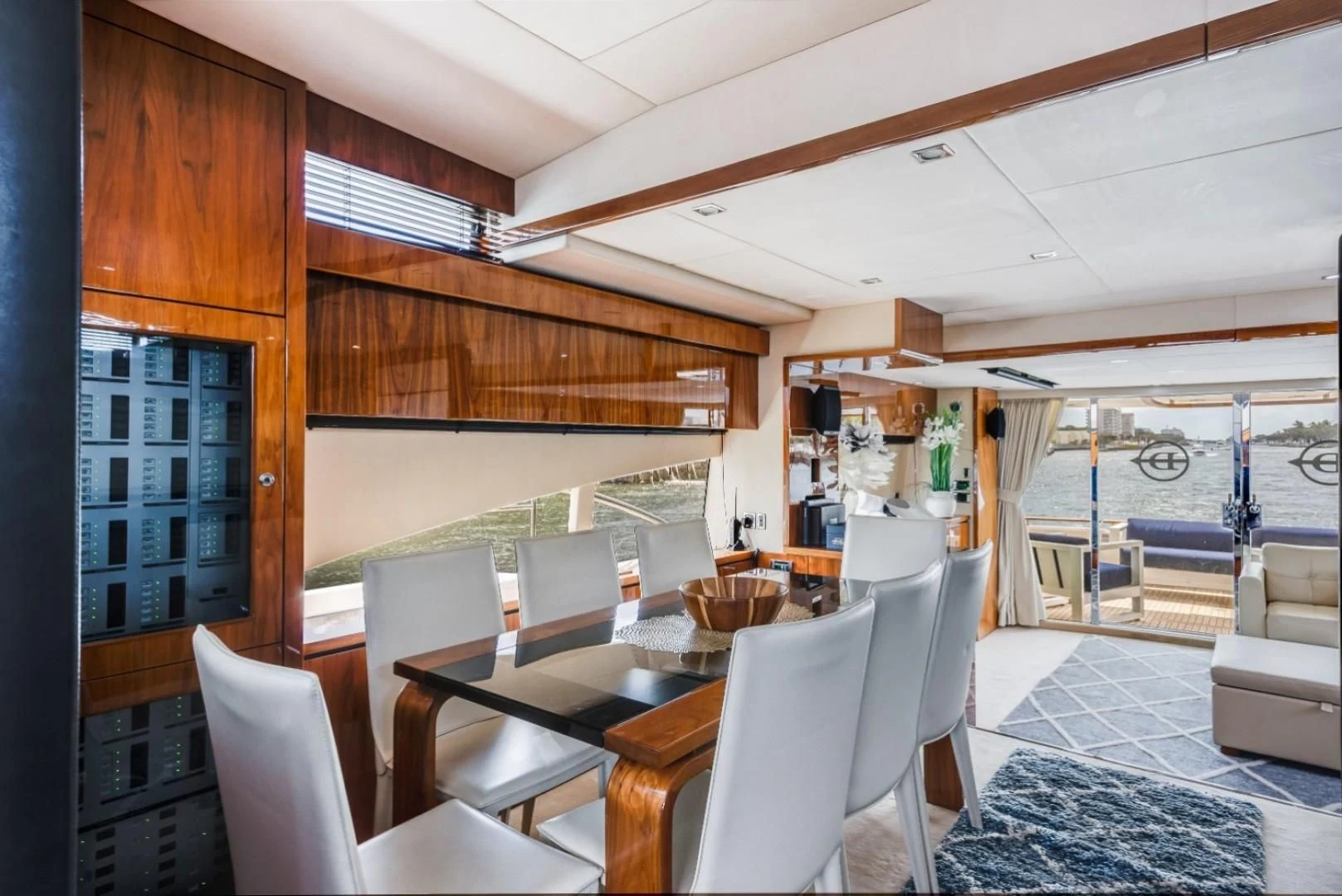 a room with a table chairs and a large window aboard DIRECT TO Yacht for Sale