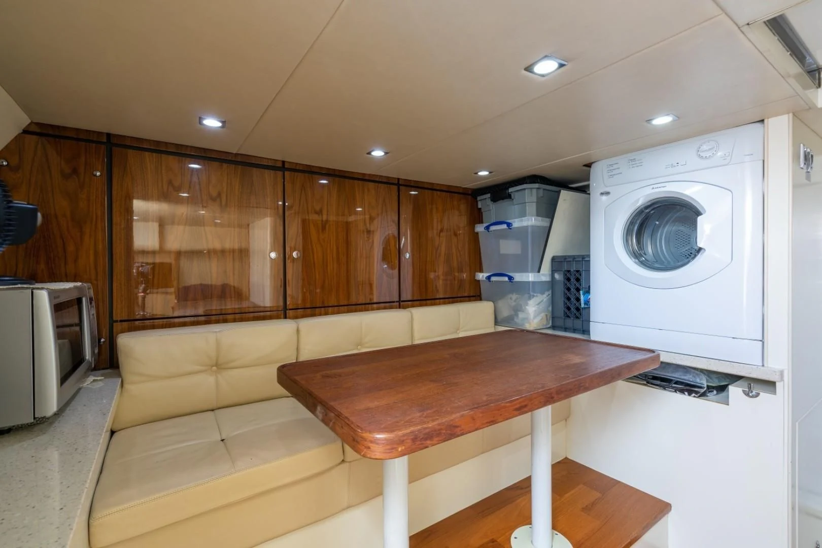 a kitchen with a table and a couch aboard DIRECT TO Yacht for Sale