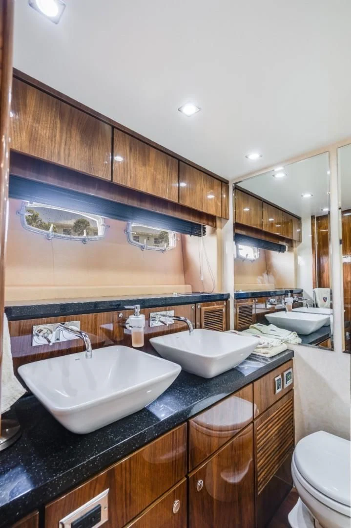 a bathroom with a sink and a toilet aboard DIRECT TO Yacht for Sale
