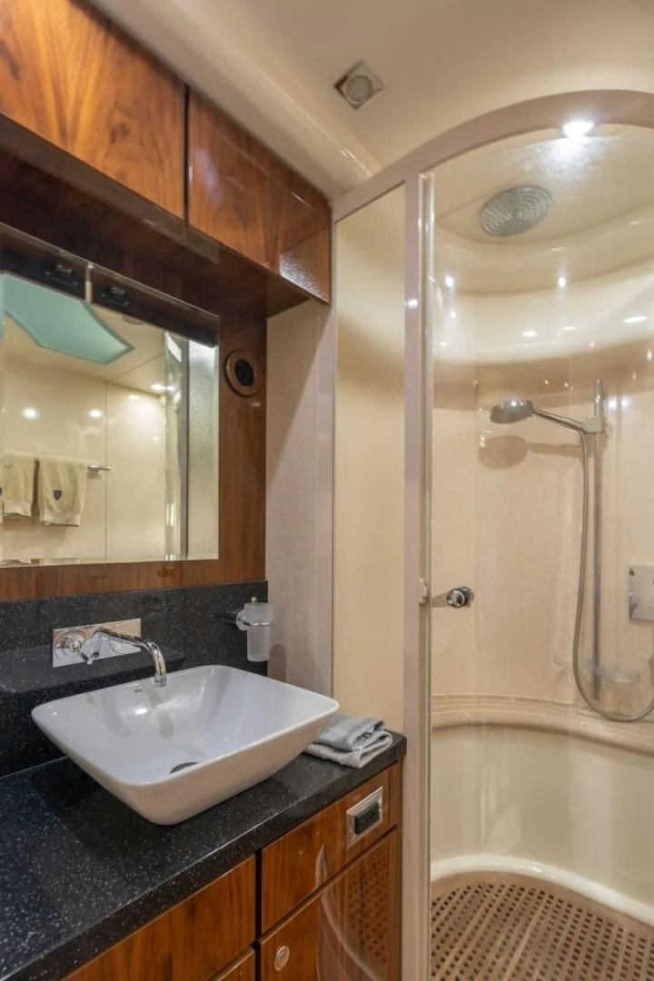 a bathroom with a sink and a shower aboard DIRECT TO Yacht for Sale