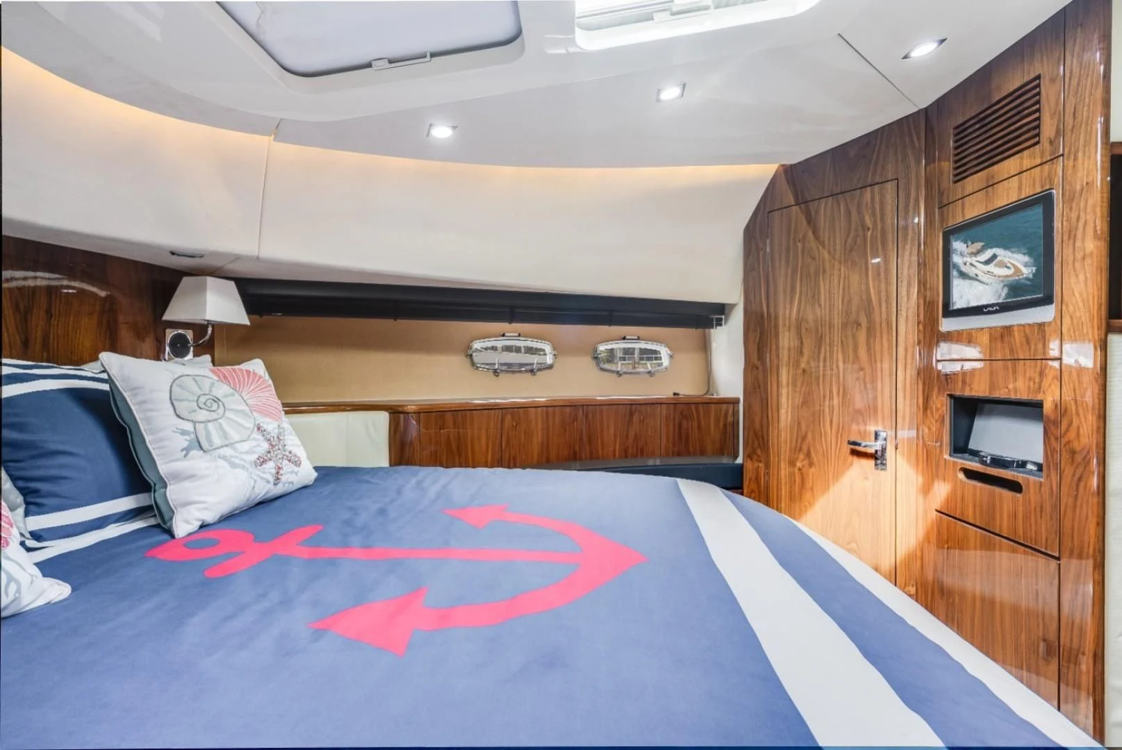 a bed with a red blanket aboard DIRECT TO Yacht for Sale