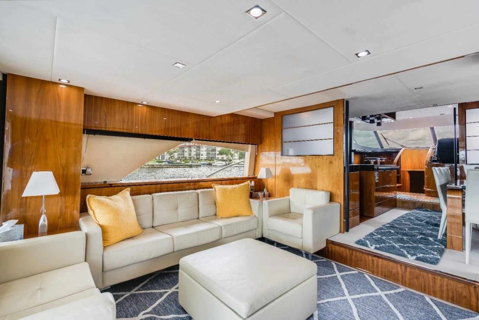 a living room with a large mirror aboard DIRECT TO Yacht for Sale
