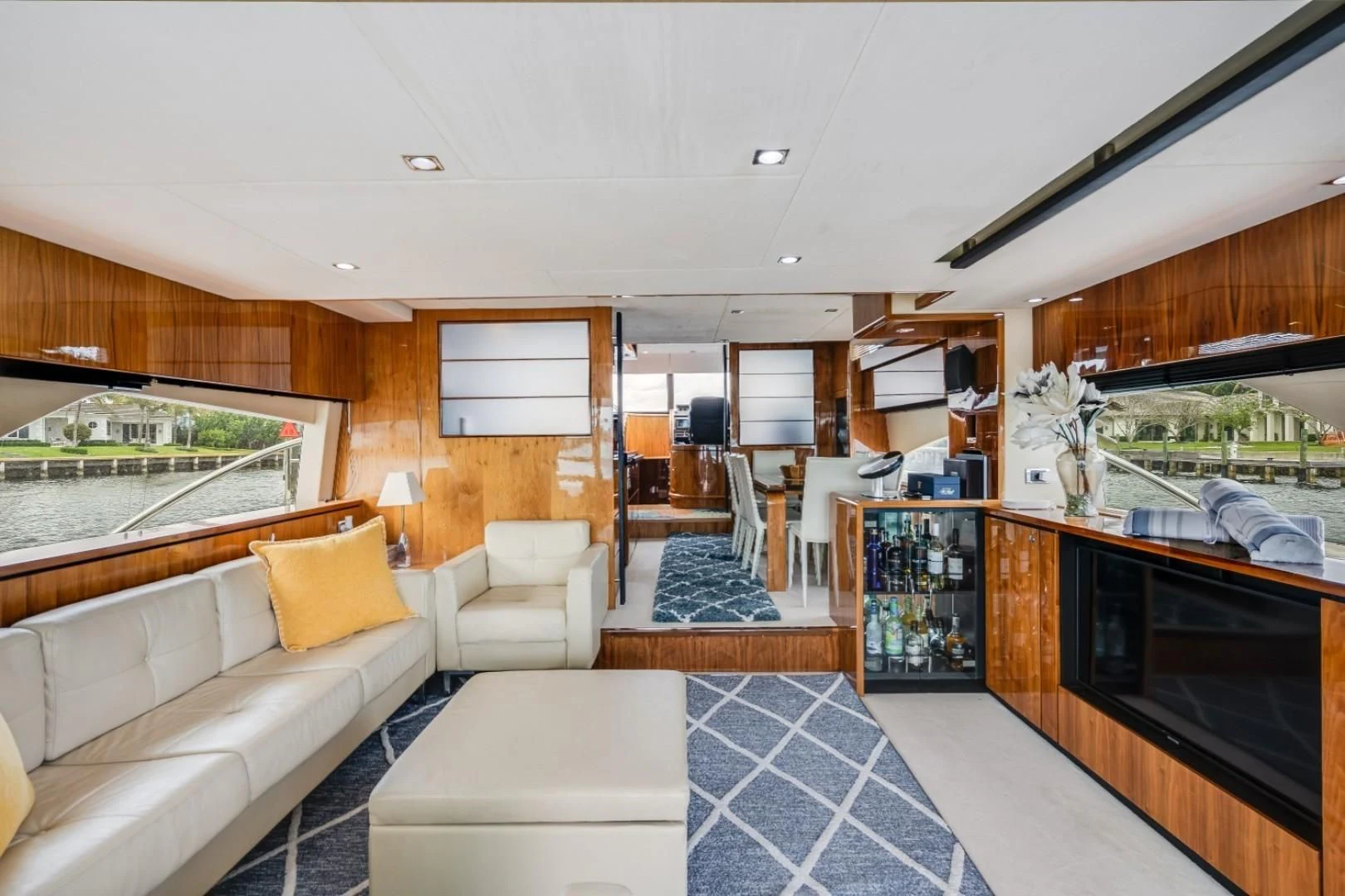 a living room with a large tv aboard DIRECT TO Yacht for Sale