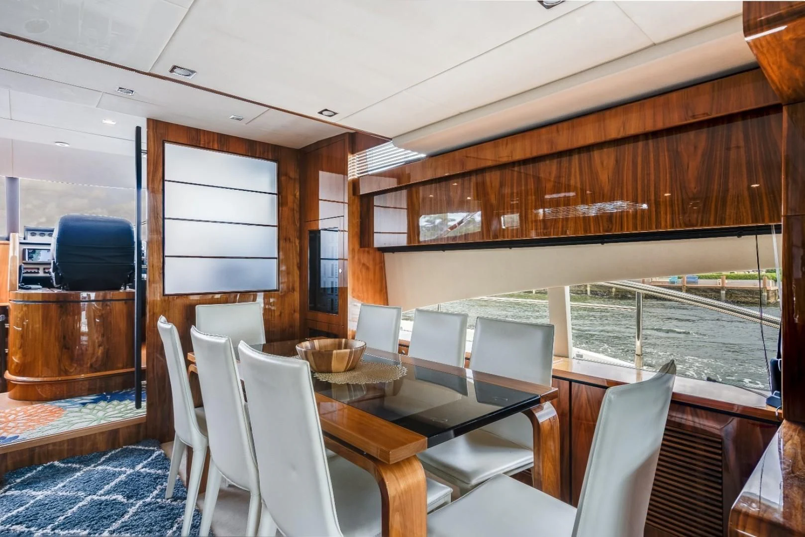 a room with a table chairs and a tv aboard DIRECT TO Yacht for Sale