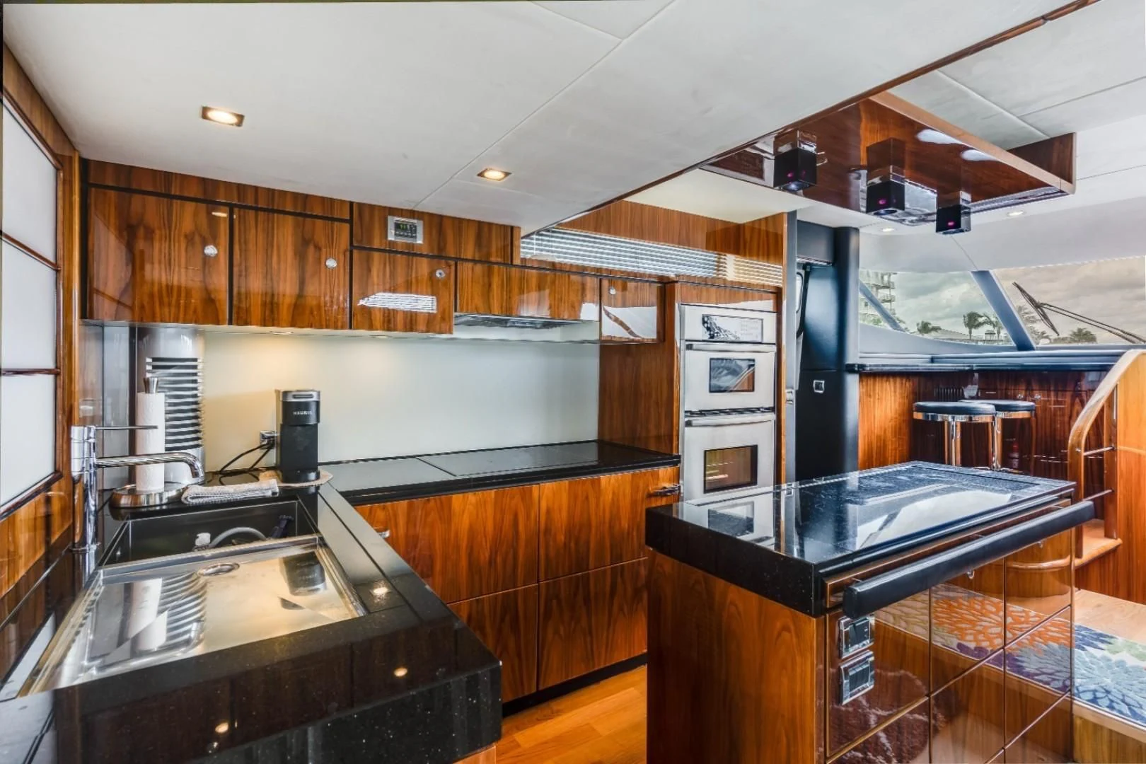 a kitchen with wooden cabinets aboard DIRECT TO Yacht for Sale