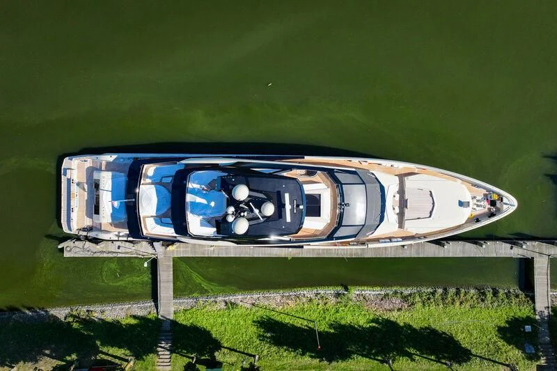 a blue and white bus on a road aboard ULTRA G Yacht for Sale