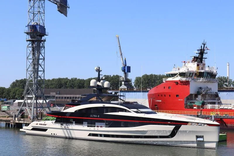 a couple of boats sit in a harbor aboard ULTRA G Yacht for Sale