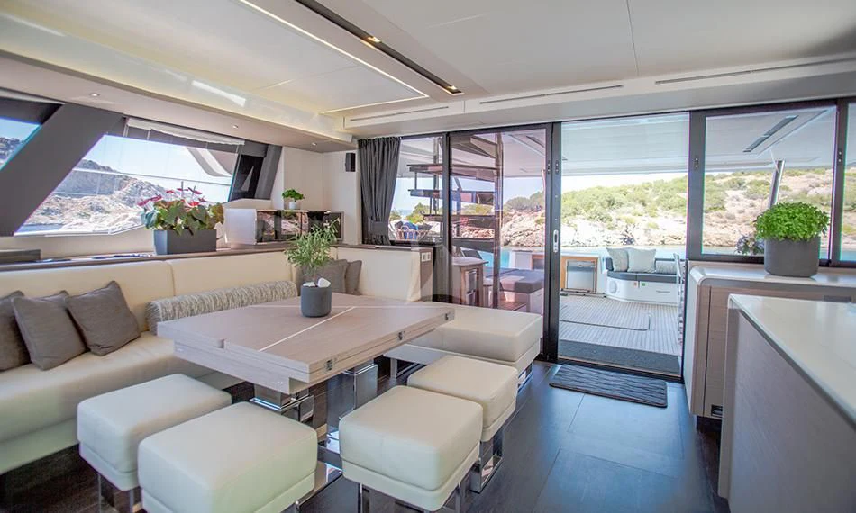 a room with a table and couches aboard PRINCESS MILA Yacht for Charter