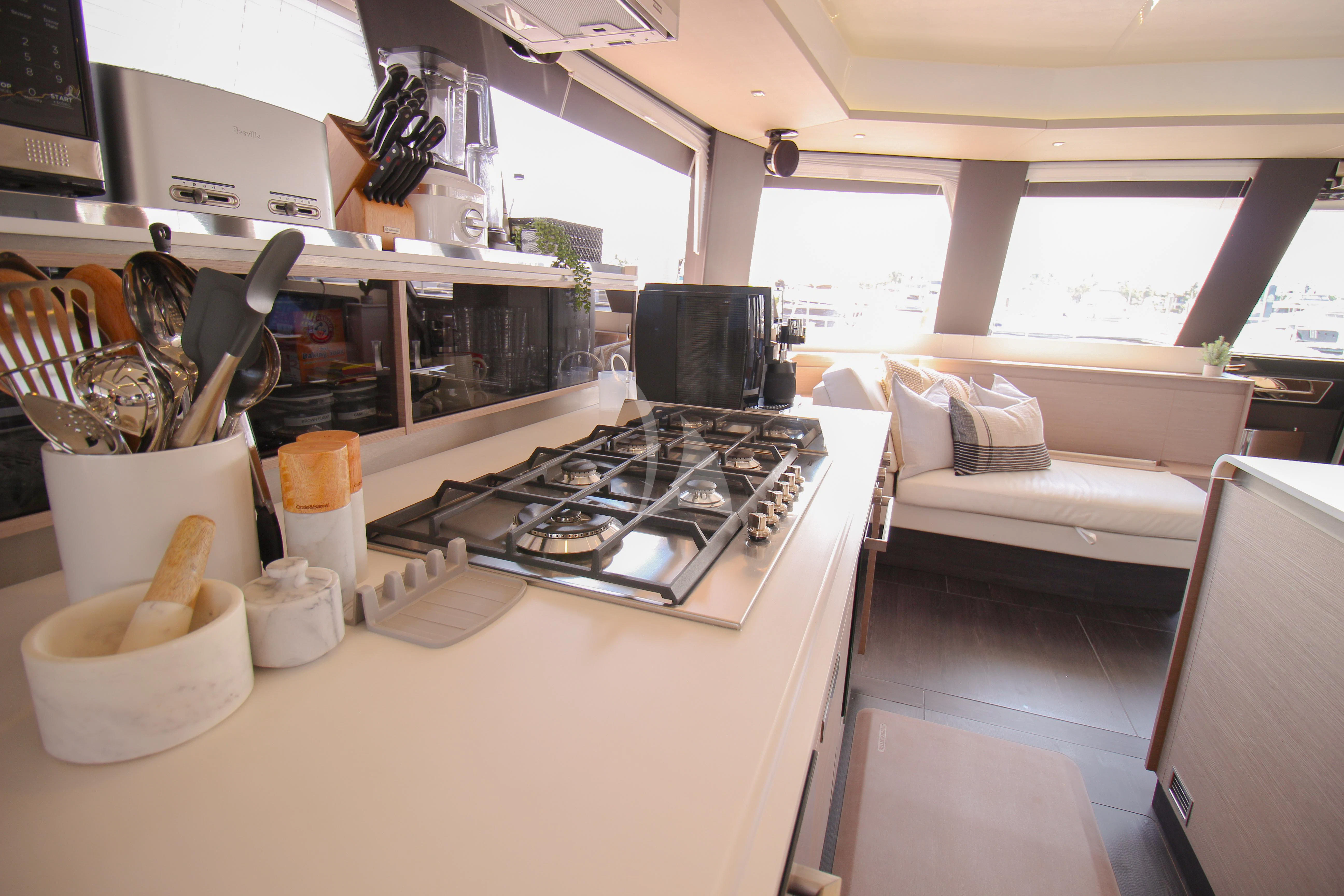 a kitchen with a couch and a coffee maker aboard PRINCESS MILA Yacht for Charter