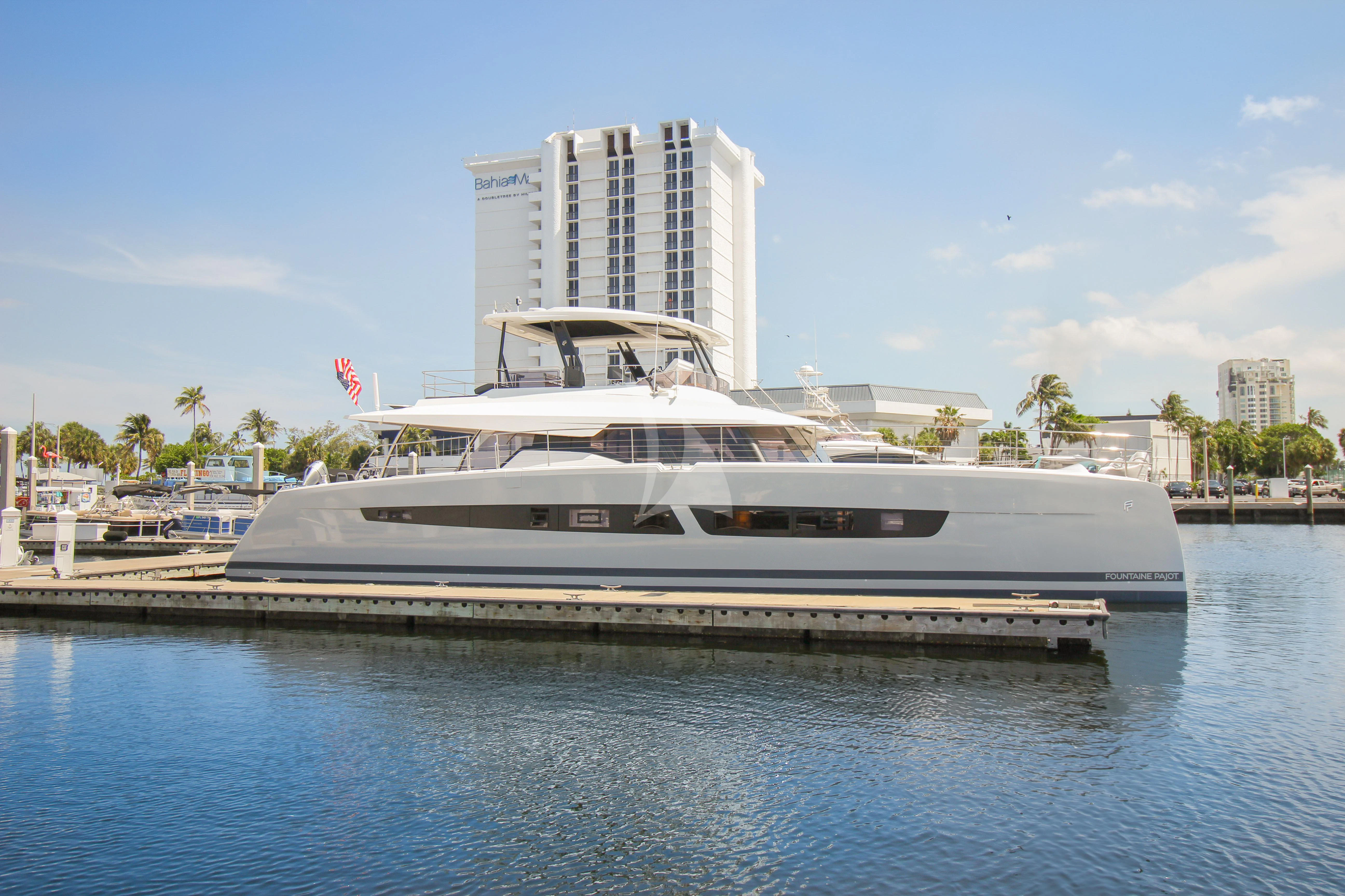 a large white boat on the water aboard PRINCESS MILA Yacht for Charter