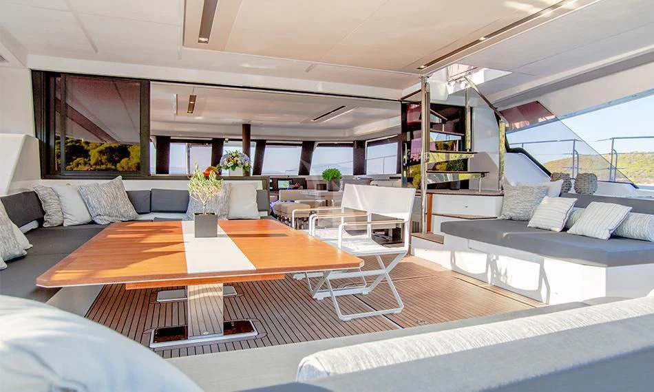 a room with a couch and a table and a bed aboard PRINCESS MILA Yacht for Charter