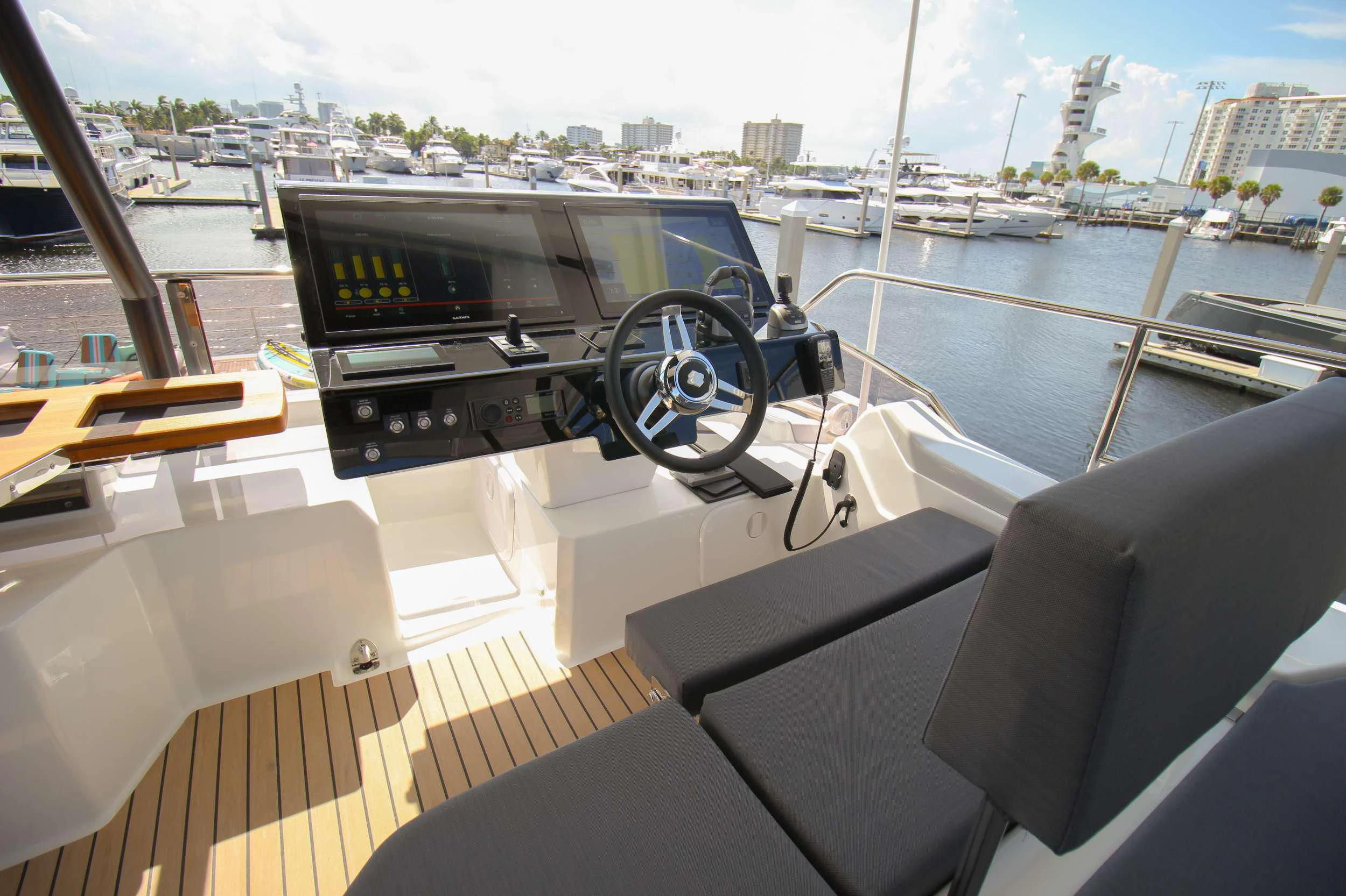 a boat with a steering wheel and a boat in the background aboard PRINCESS MILA Yacht for Charter