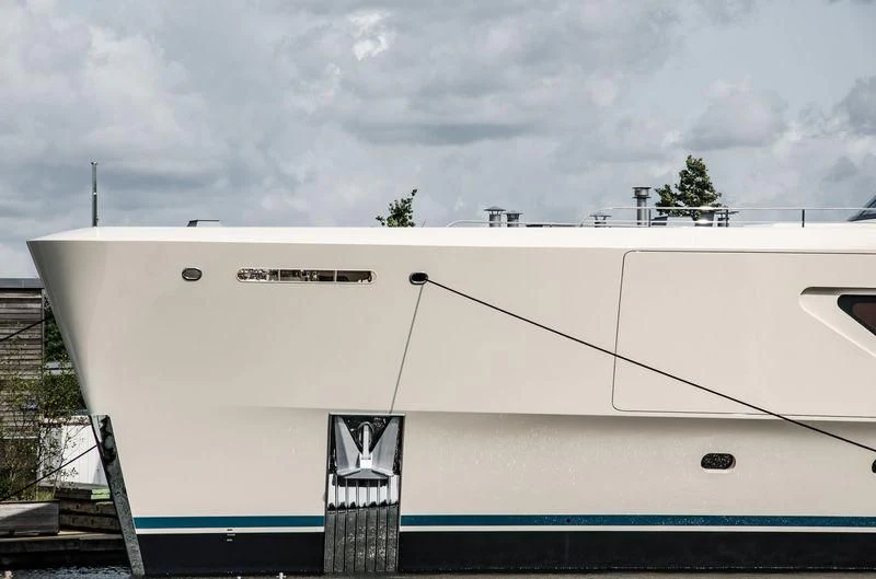 a white boat with a blue stripe aboard SAMAYA Yacht for Sale