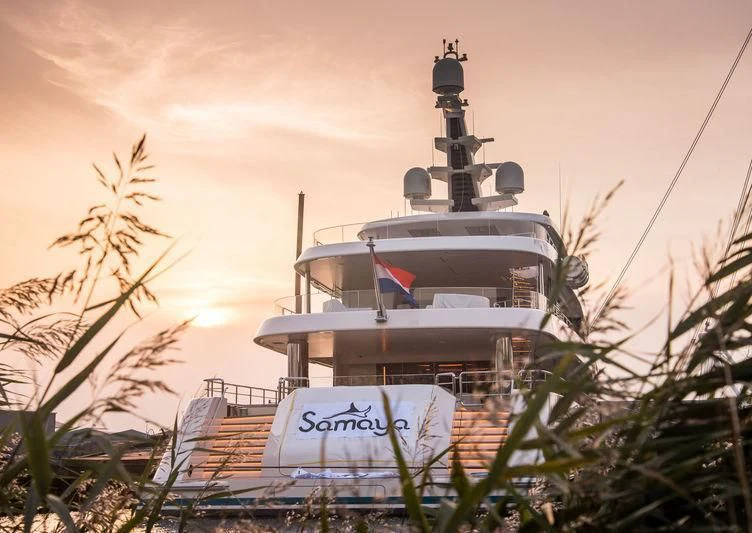 a large white ship in a tropical setting aboard SAMAYA Yacht for Sale