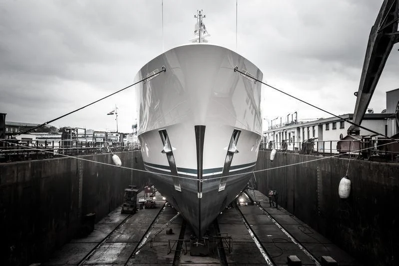 a large white ship on a dock aboard SAMAYA Yacht for Sale