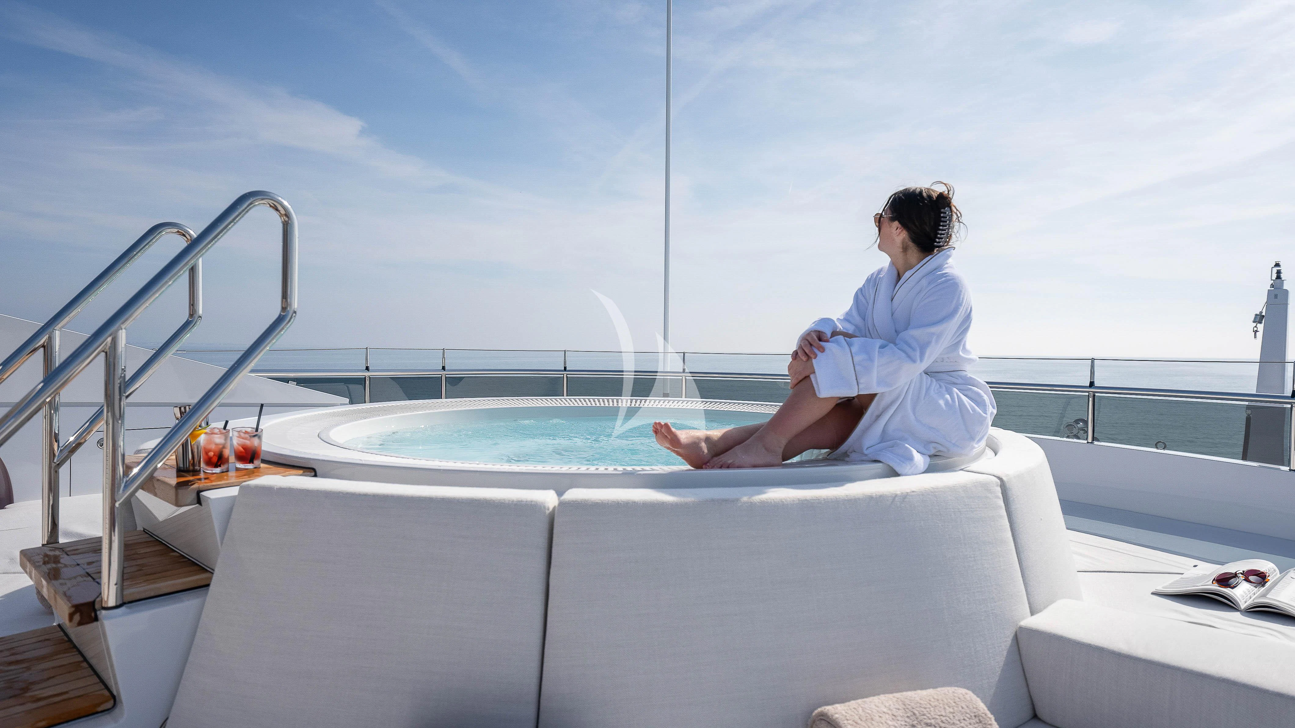 a person sitting on a couch aboard RELIANCE Yacht for Sale