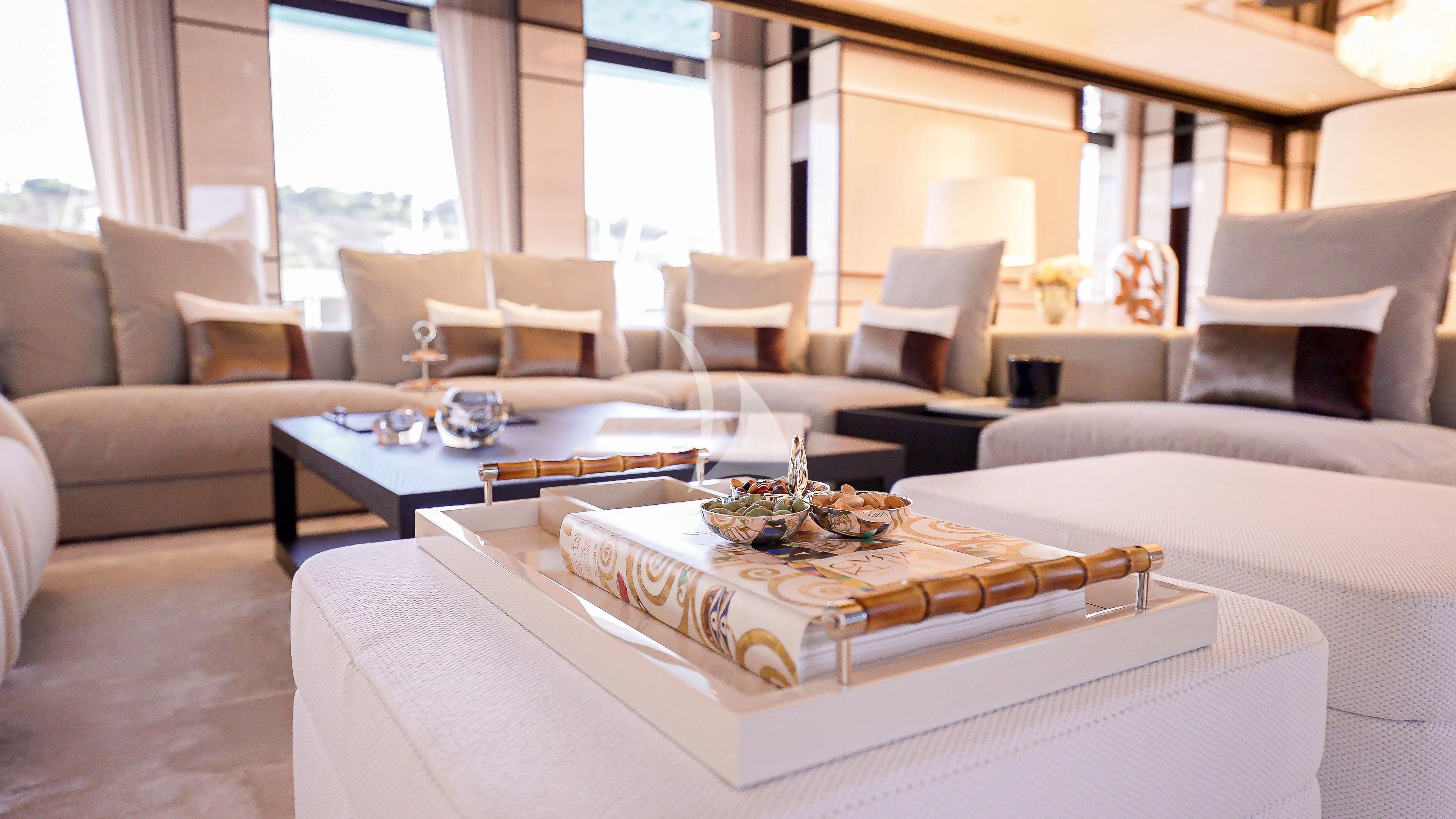 a living room with a large white table and white couches aboard RELIANCE Yacht for Sale