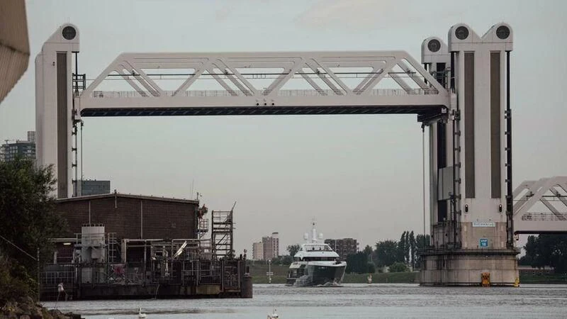 a large white structure with a tower next to a boat aboard RELIANCE Yacht for Sale