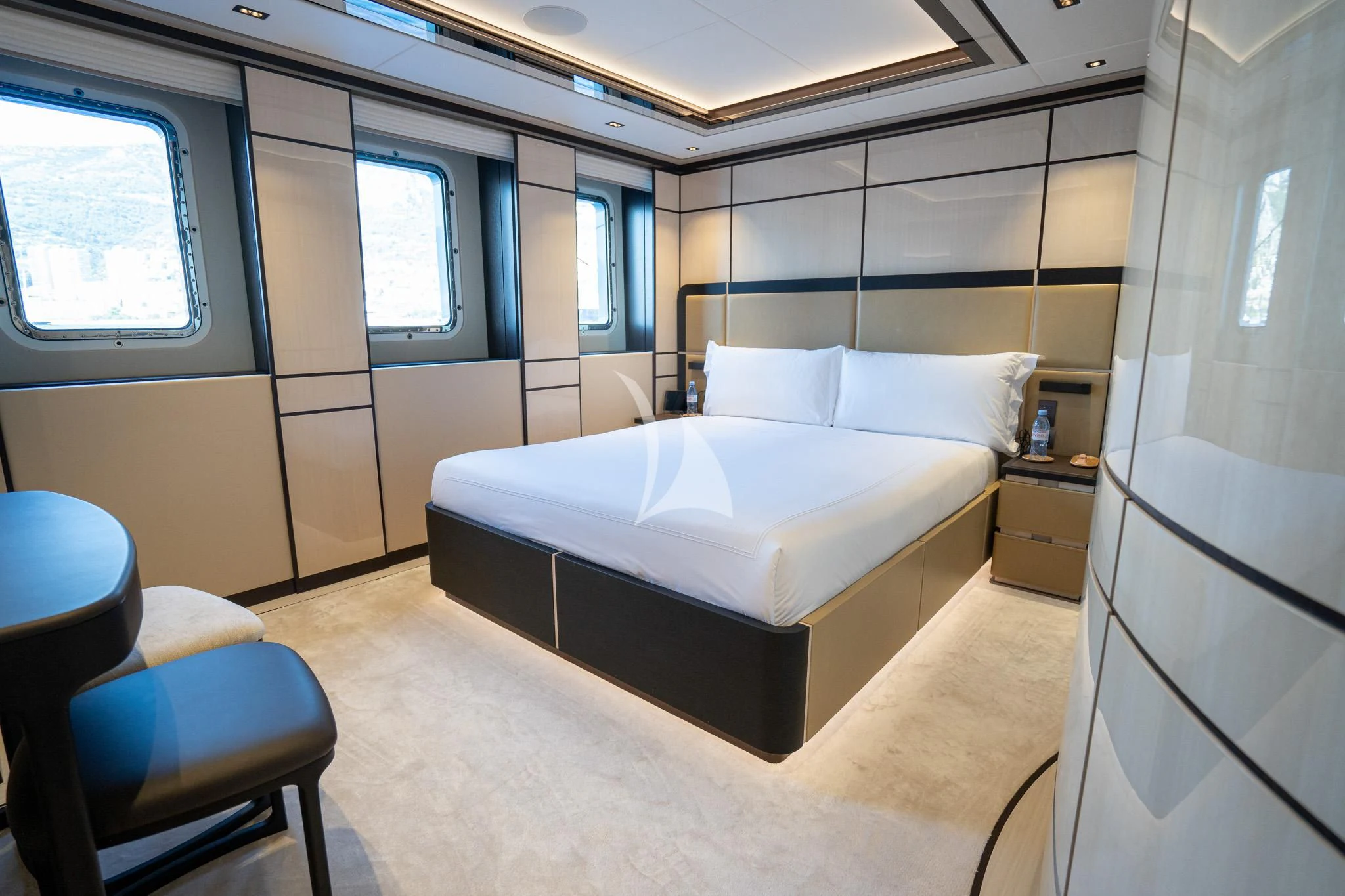 a room with a bed and a chair aboard RELIANCE Yacht for Sale