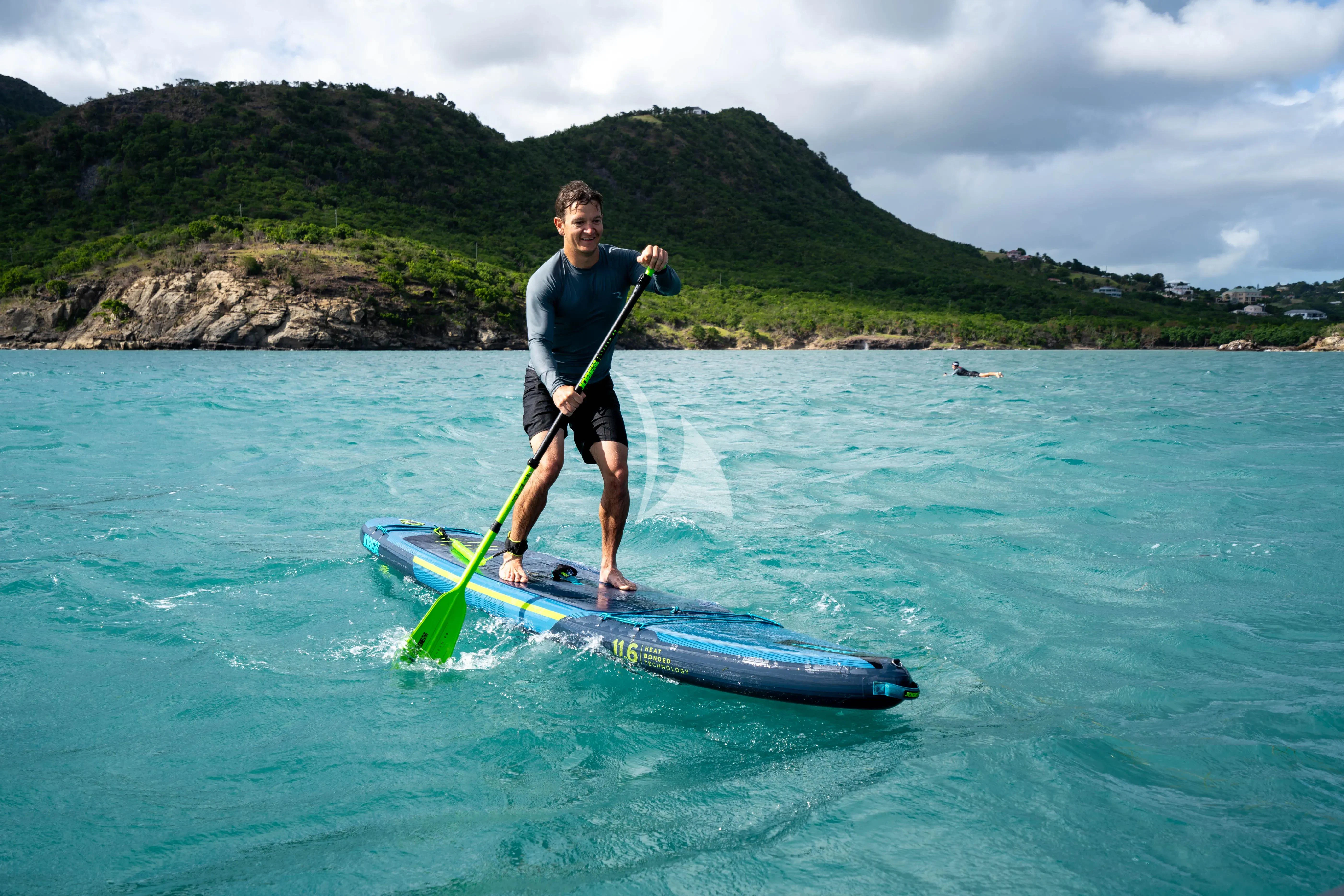 a man on a paddle board in the water aboard RELIANCE Yacht for Sale